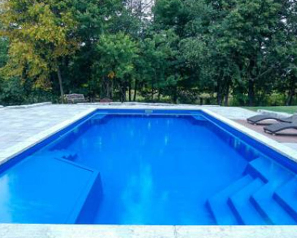 Whitsunday Lounger fiberglass pool with fire pit and retaining wall Hartford AL